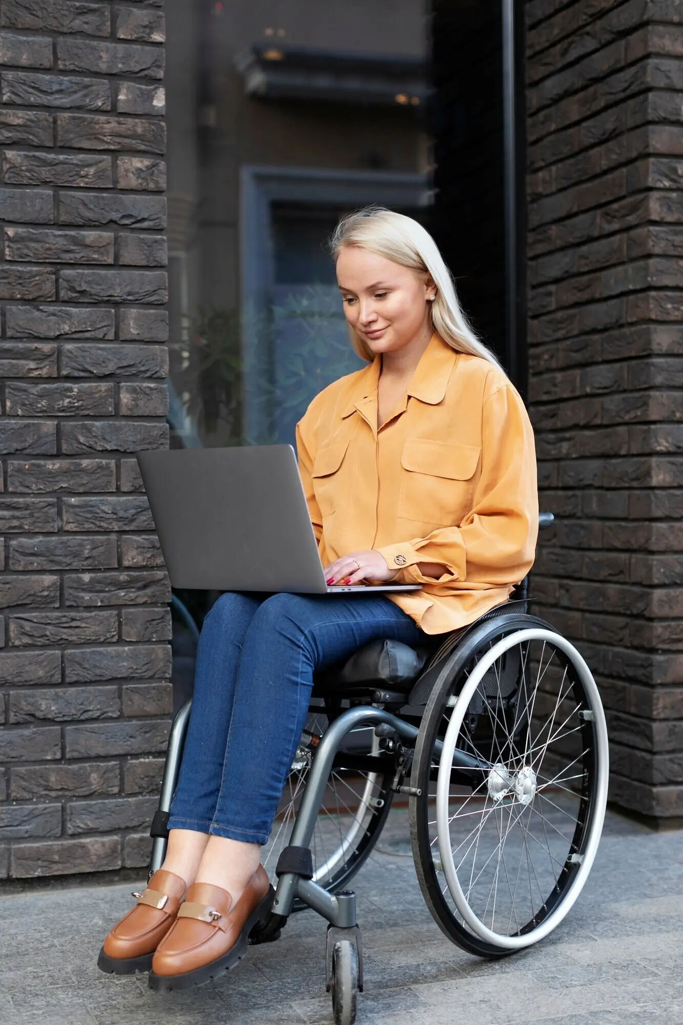 A person with a disability in a wheelchair on the street.